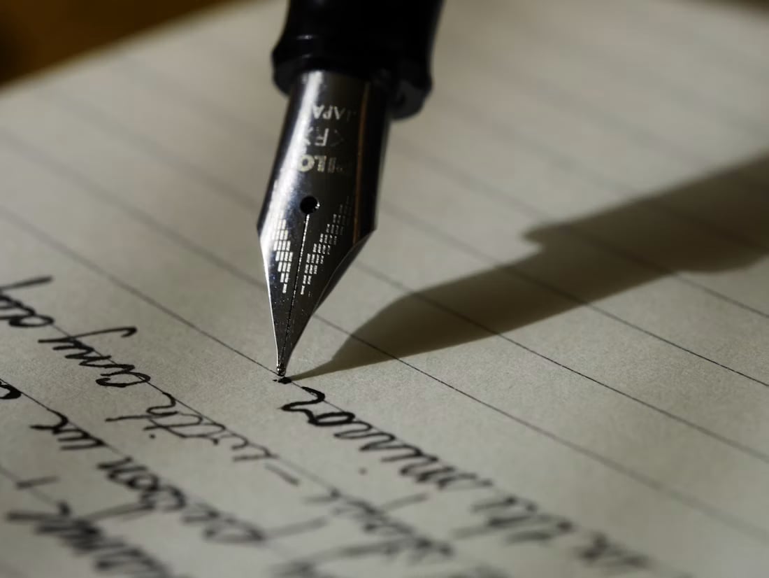 Close-up of a fountain pen and handwritten notes